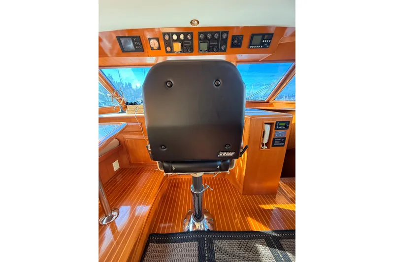 Island Girl Yacht Photos Pics 1997 Ocean Alexander 486 Pilothouse helm with captain's chair and control panel.