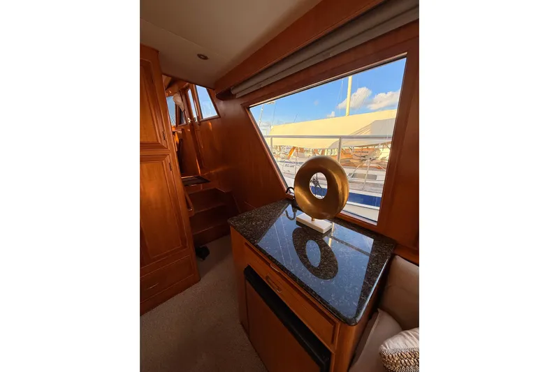 Island Girl Yacht Photos Pics Interior of 1997 Ocean Alexander 486 Pilothouse with wooden cabinetry and decorative sculpture.