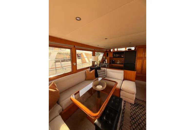Island Girl Yacht Photos Pics Luxurious interior of 1997 Ocean Alexander 486 Pilothouse yacht with elegant seating and dining area.