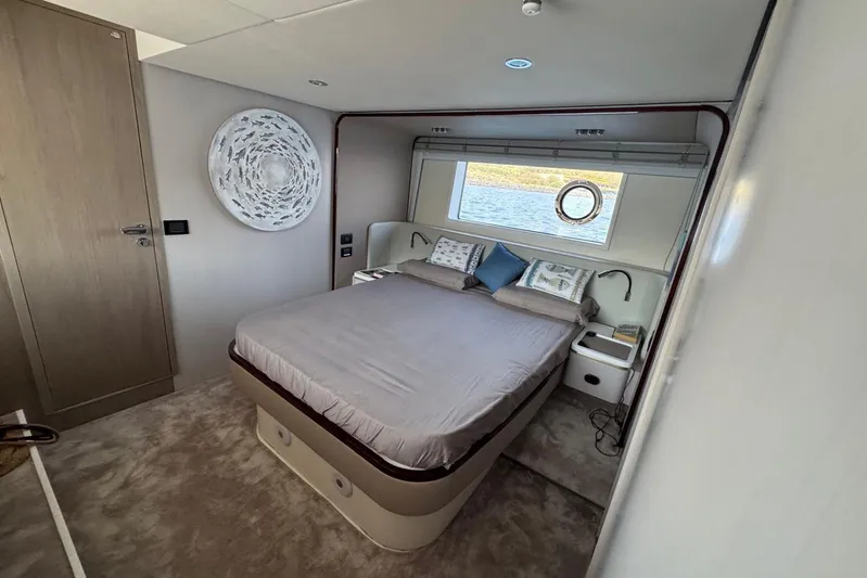  Yacht Photos Pics Luxurious bedroom interior of 2024 Azimut 60 yacht with elegant decor and sea view.