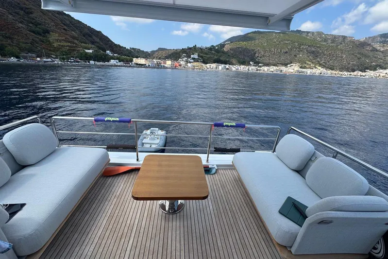  Yacht Photos Pics Luxurious 2024 Azimut 60 yacht deck with scenic coastal view.