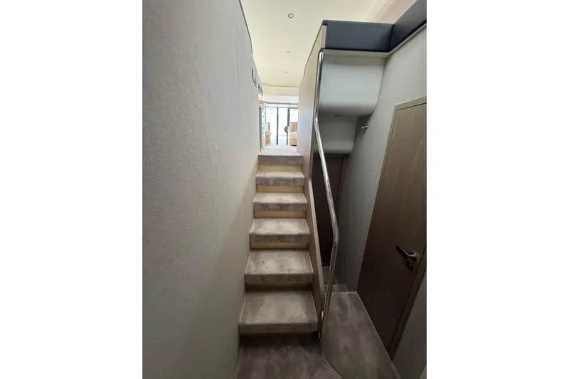  Yacht Photos Pics Interior staircase of 2024 Azimut 60 yacht, featuring modern design and sleek finishes.