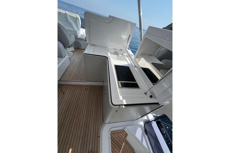  Yacht Photos Pics 2024 Azimut 60 yacht deck with open storage compartments and ocean view.