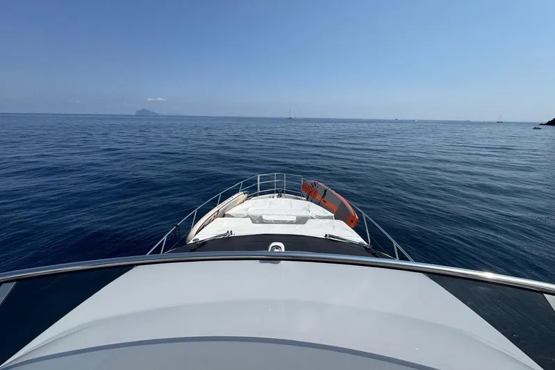  Yacht Photos Pics 2024 Azimut 60 yacht cruising on calm blue ocean waters.