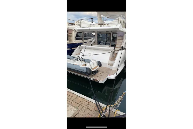  Yacht Photos Pics 2024 Azimut 60 yacht docked with tender boat at marina.