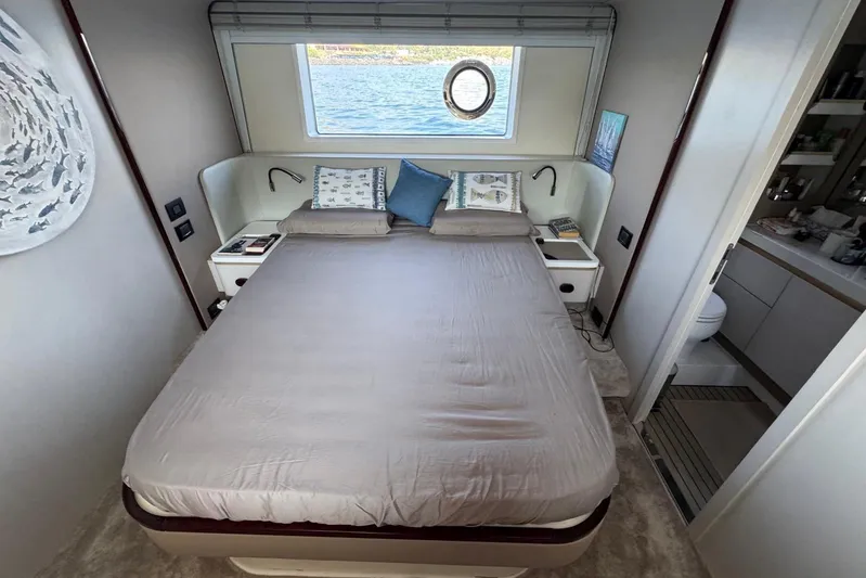  Yacht Photos Pics Luxurious bedroom interior of 2024 Azimut 60 yacht with scenic window view.