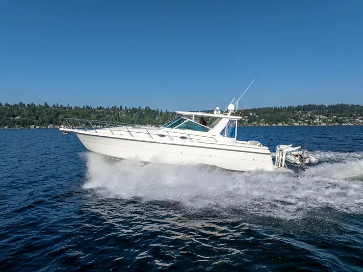  Yacht Photos Pics 2001 Tiara Sport 4000 EXPRESS cruising on a lake under clear blue skies.