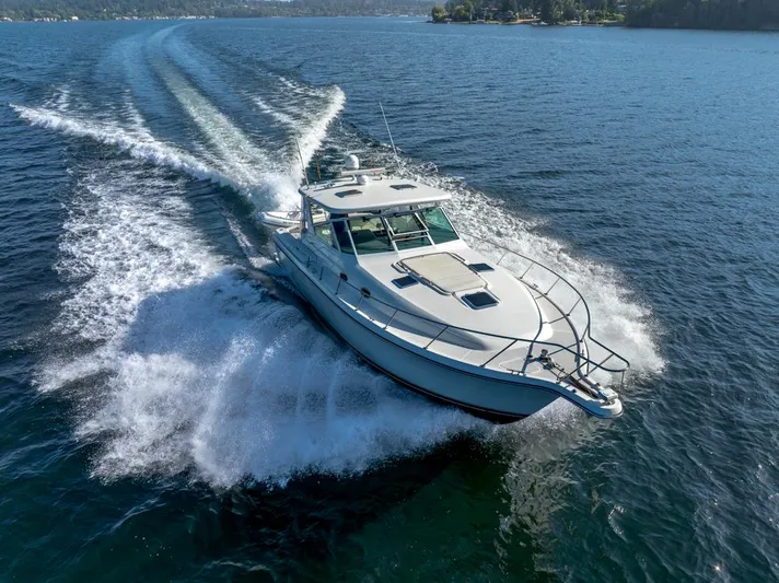  Yacht Photos Pics 2001 Tiara Sport 4000 EXPRESS cruising on open water, creating a dynamic wake.