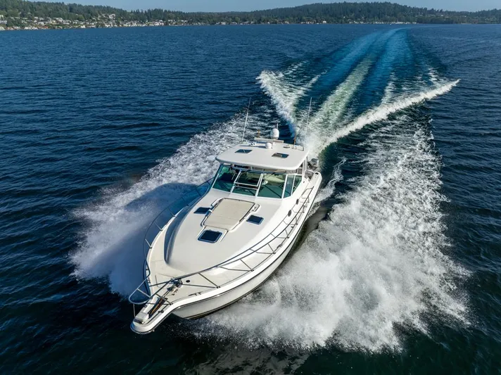  Yacht Photos Pics 2001 Tiara Sport 4000 EXPRESS cruising on open water, creating a dynamic wake.