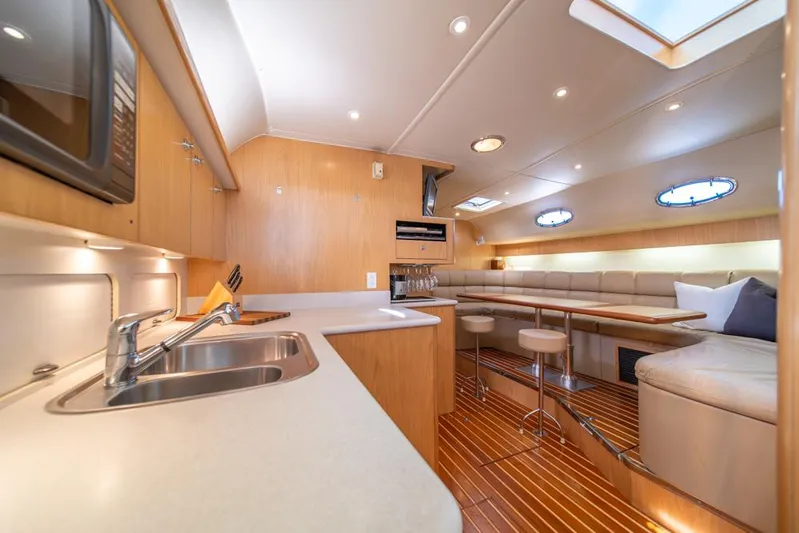  Yacht Photos Pics Luxurious interior of 2001 Tiara Sport 4000 EXPRESS yacht with modern kitchen and seating area.