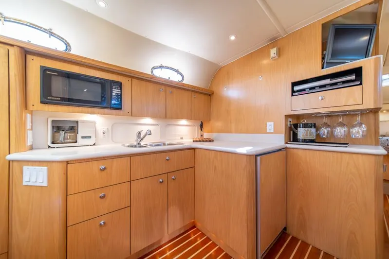  Yacht Photos Pics Luxurious 2001 Tiara Sport 4000 EXPRESS yacht kitchen with modern amenities and wood cabinetry.