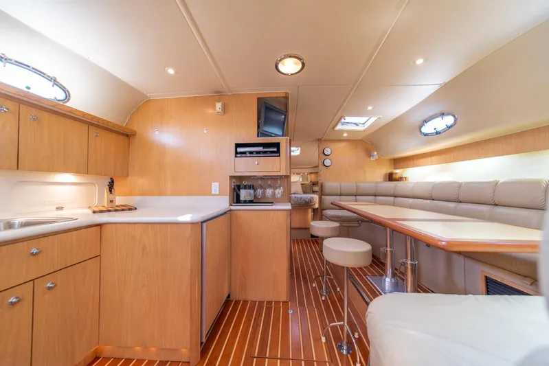  Yacht Photos Pics Luxurious interior of 2001 Tiara Sport 4000 EXPRESS yacht with modern kitchen and seating area.