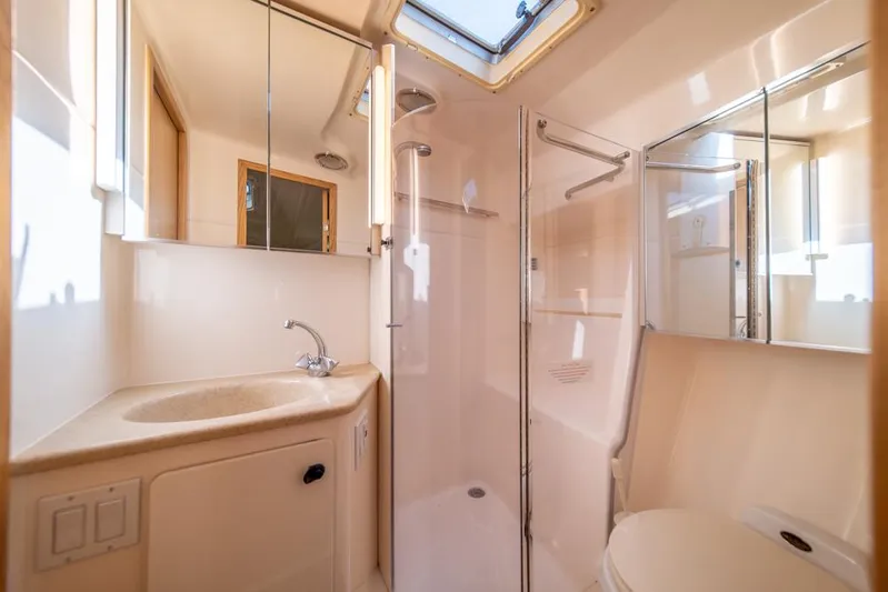  Yacht Photos Pics Luxurious bathroom in 2001 Tiara Sport 4000 EXPRESS yacht, featuring shower and vanity.