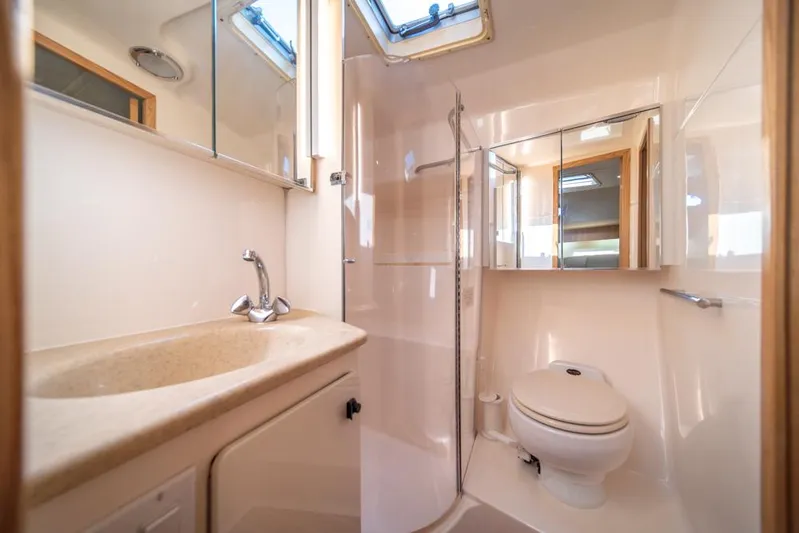  Yacht Photos Pics Luxurious bathroom in 2001 Tiara Sport 4000 EXPRESS yacht, featuring modern fixtures and skylight.