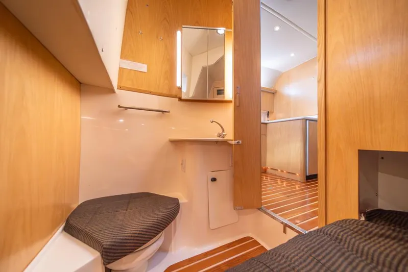  Yacht Photos Pics Interior of 2001 Tiara Sport 4000 EXPRESS yacht, featuring wooden cabinetry and compact bathroom.