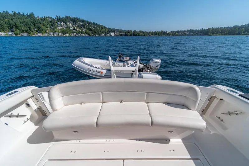  Yacht Photos Pics 2001 Tiara Sport 4000 EXPRESS yacht with white seating, docked on a serene lake.