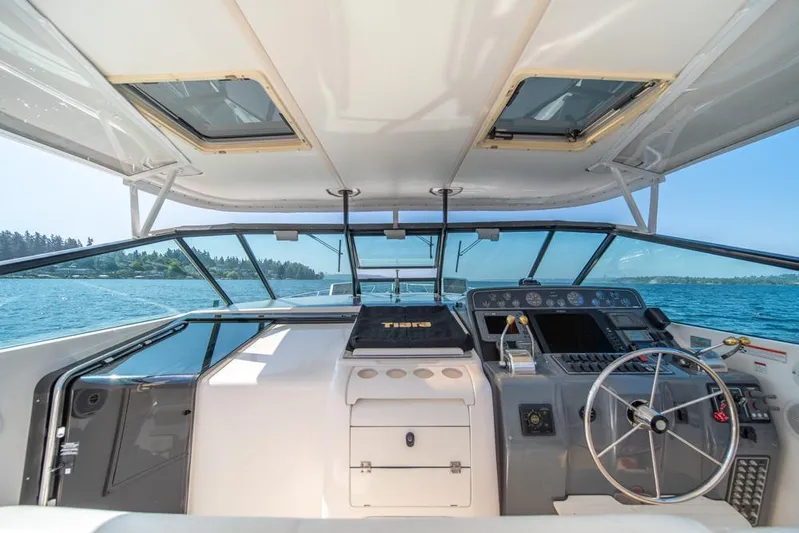  Yacht Photos Pics 2001 Tiara Sport 4000 EXPRESS yacht cockpit with steering wheel, dashboard, and ocean view.