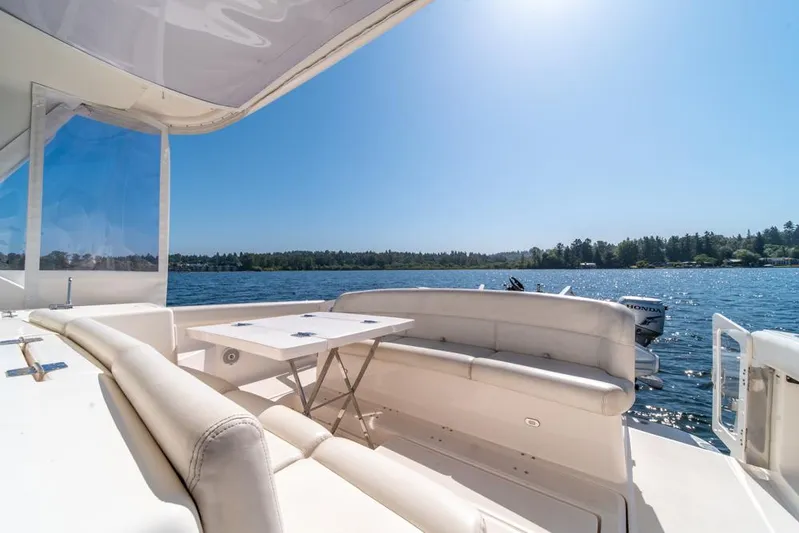  Yacht Photos Pics 2001 Tiara Sport 4000 EXPRESS yacht with spacious seating, overlooking serene lake and forest.