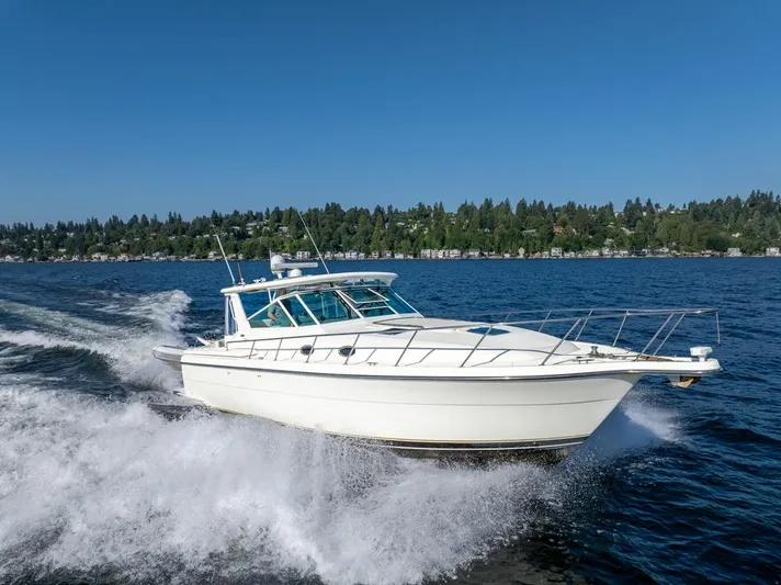  Yacht Photos Pics 2001 Tiara Sport 4000 EXPRESS cruising on a lake under clear blue skies.