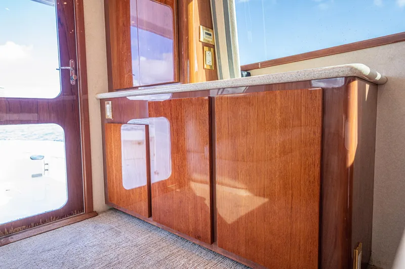 Manana Yacht Photos Pics Interior of 2007 Egg Harbor 43 SportYacht with polished wood cabinetry and ocean view.