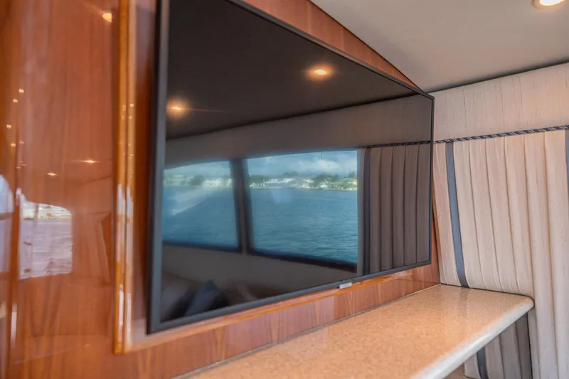 Manana Yacht Photos Pics Interior of 2007 Egg Harbor 43 SportYacht with large TV and window reflection.