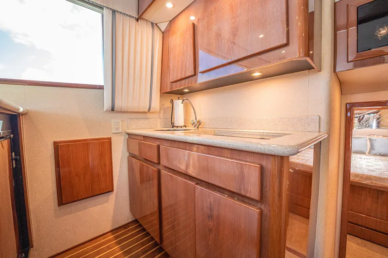 Manana Yacht Photos Pics Luxurious 2007 Egg Harbor 43 SportYacht kitchen with wood cabinetry and modern fixtures.