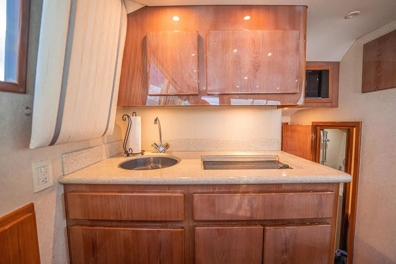 Manana Yacht Photos Pics 2007 Egg Harbor 43 SportYacht kitchen with wood cabinets and modern sink.