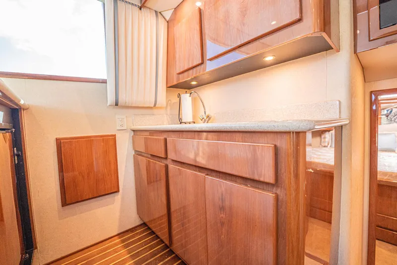 Manana Yacht Photos Pics Luxurious 2007 Egg Harbor 43 SportYacht interior with elegant wood cabinetry and modern fixtures.