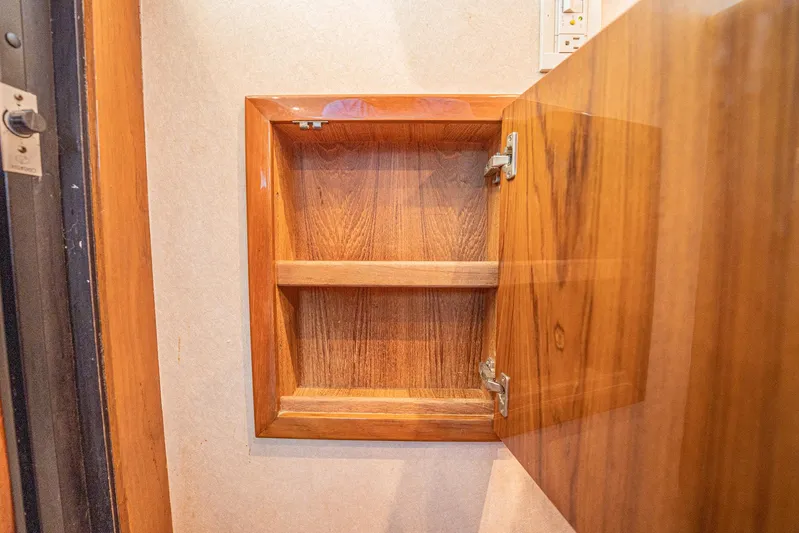 Manana Yacht Photos Pics Wooden cabinet interior on a 2007 Egg Harbor 43 SportYacht, showcasing open shelving.
