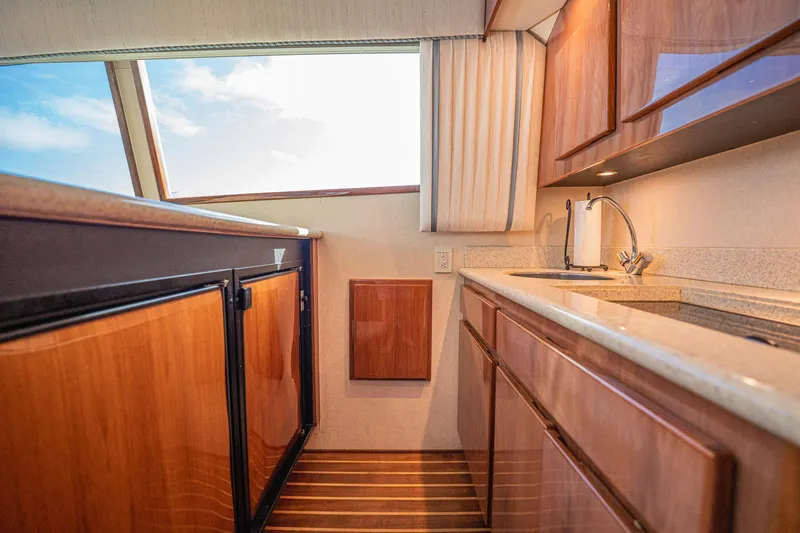 Manana Yacht Photos Pics 2007 Egg Harbor 43 SportYacht kitchen with wood cabinetry and modern fixtures.