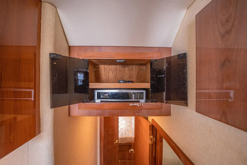 Manana Yacht Photos Pics 2007 Egg Harbor 43 SportYacht interior with open wooden cabinet and microwave.