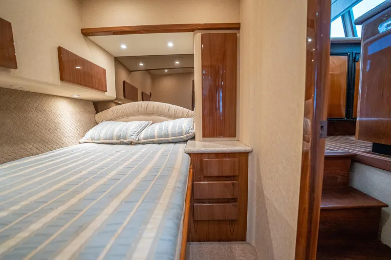 Manana Yacht Photos Pics Luxurious cabin interior of 2007 Egg Harbor 43 SportYacht with cozy bed and wooden accents.