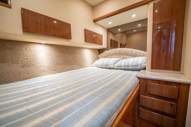 Manana Yacht Photos Pics Luxurious cabin interior of 2007 Egg Harbor 43 SportYacht with cozy bedding and wood finishes.