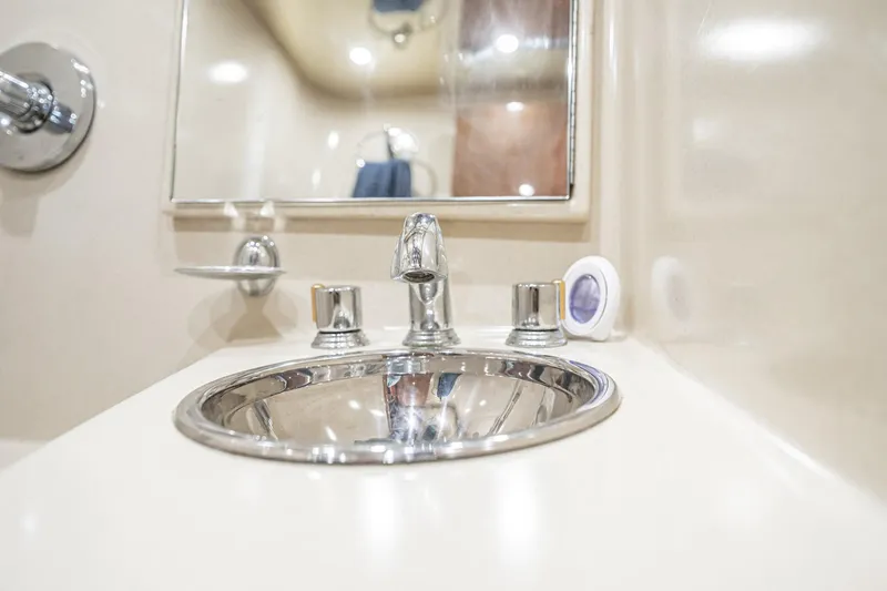 Manana Yacht Photos Pics Luxurious bathroom sink in 2007 Egg Harbor 43 SportYacht, featuring chrome fixtures and mirror.