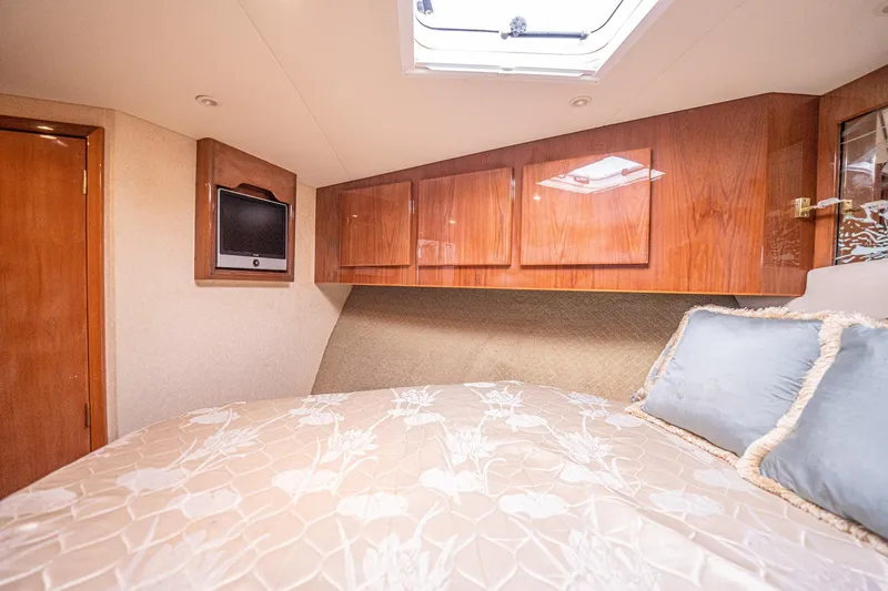 Manana Yacht Photos Pics Luxurious cabin interior of 2007 Egg Harbor 43 SportYacht with wood cabinets and cozy bedding.