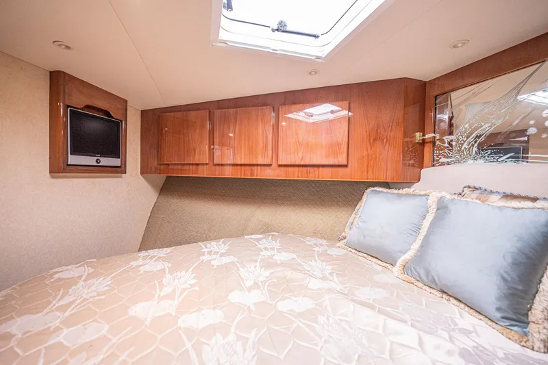 Manana Yacht Photos Pics Luxurious cabin interior of 2007 Egg Harbor 43 SportYacht with elegant bedding and wood cabinetry.