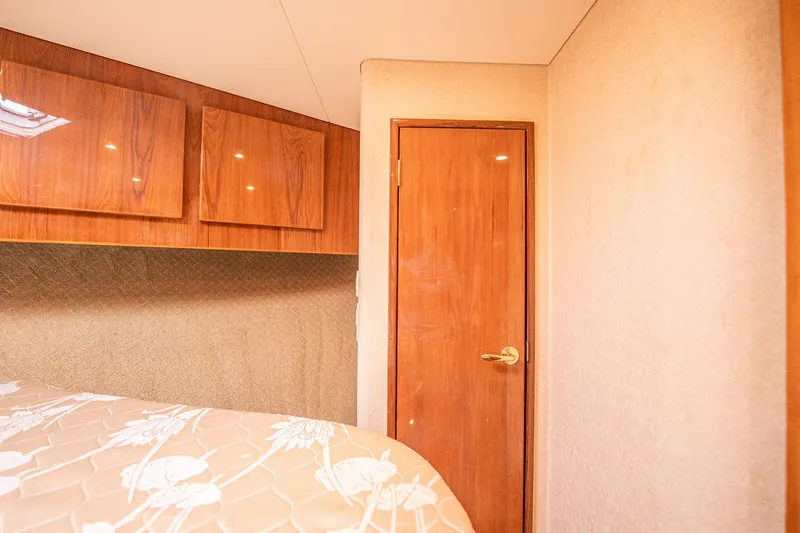 Manana Yacht Photos Pics Interior cabin of 2007 Egg Harbor 43 SportYacht with wooden door and cabinets.