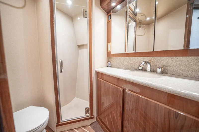 Manana Yacht Photos Pics Luxurious bathroom in 2007 Egg Harbor 43 SportYacht with shower, vanity, and toilet.