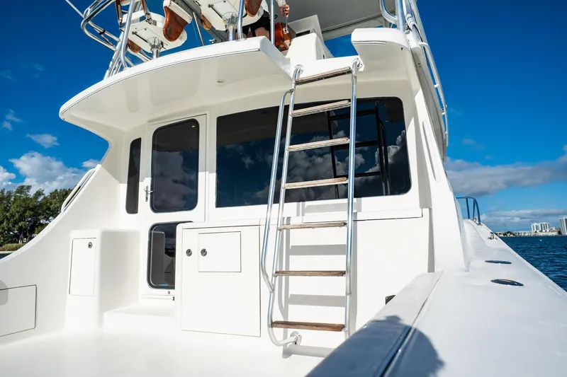 Manana Yacht Photos Pics 2007 Egg Harbor 43 SportYacht with ladder, docked under clear blue sky.