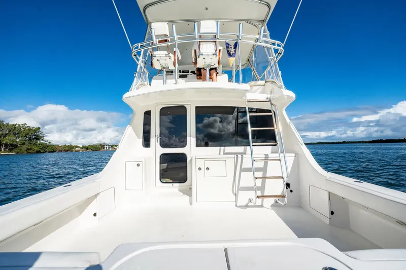 Manana Yacht Photos Pics 2007 Egg Harbor 43 SportYacht on calm waters, featuring spacious deck and ladder.
