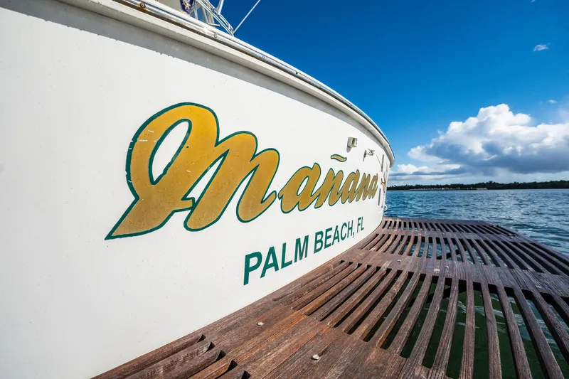 Manana Yacht Photos Pics Egg Harbor 43 SportYacht 2007 docked in Palm Beach, FL, under clear blue skies.