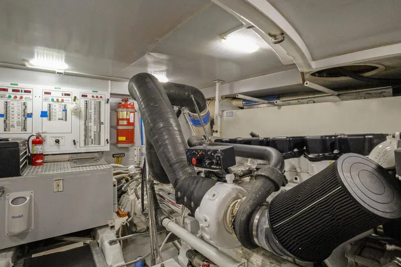 Her Endeavour Yacht Photos Pics Engine room of 2008 Marquis 690 yacht with control panels and fire extinguishers.