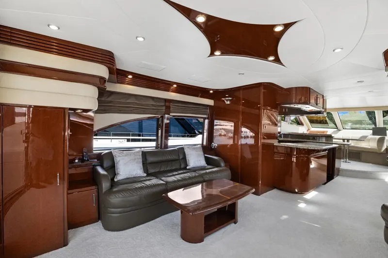 Her Endeavour Yacht Photos Pics Luxurious interior of a 2008 Marquis 690 yacht with elegant wood finishes and modern furnishings.