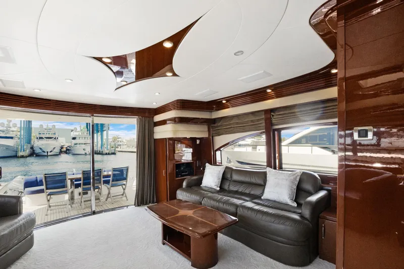 Her Endeavour Yacht Photos Pics Luxurious interior of 2008 Marquis 690 yacht with leather seating and marina view.