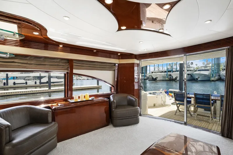 Her Endeavour Yacht Photos Pics Luxurious 2008 Marquis 690 yacht interior with elegant seating and marina view.