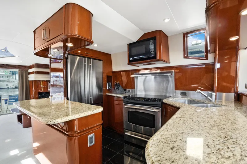 Her Endeavour Yacht Photos Pics Luxurious kitchen interior of 2008 Marquis 690 yacht with modern appliances and granite countertops.