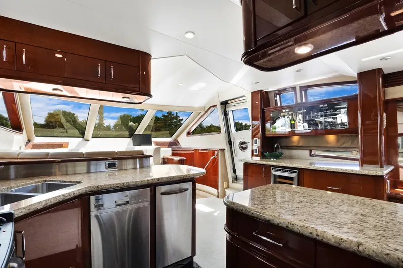 Her Endeavour Yacht Photos Pics Luxurious interior of 2008 Marquis 690 yacht with modern kitchen and panoramic windows.