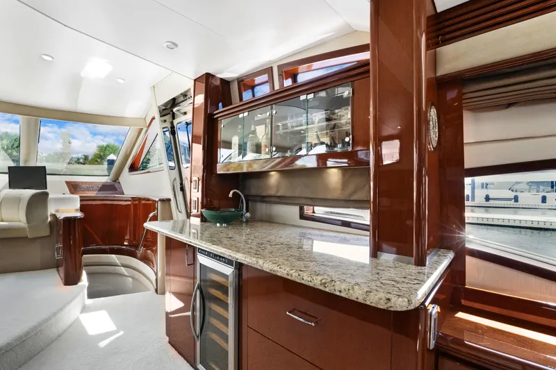 Her Endeavour Yacht Photos Pics Luxurious interior of 2008 Marquis 690 yacht with modern kitchen and elegant seating area.