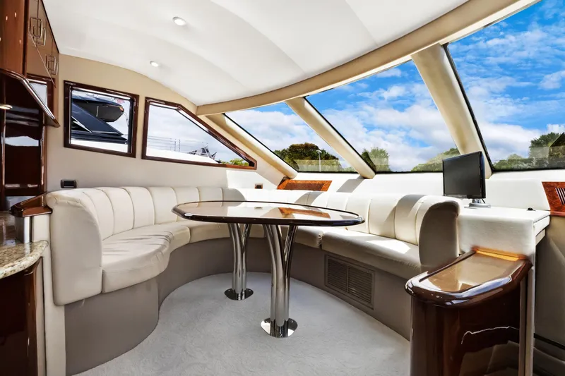 Her Endeavour Yacht Photos Pics Luxurious interior of 2008 Marquis 690 yacht with elegant seating and panoramic windows.