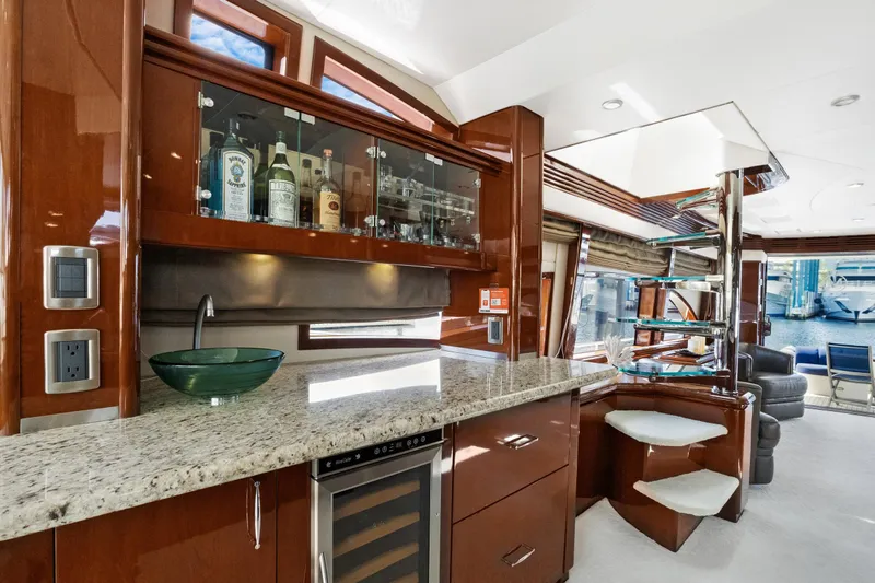 Her Endeavour Yacht Photos Pics Luxurious 2008 Marquis 690 yacht interior with elegant bar and modern amenities.